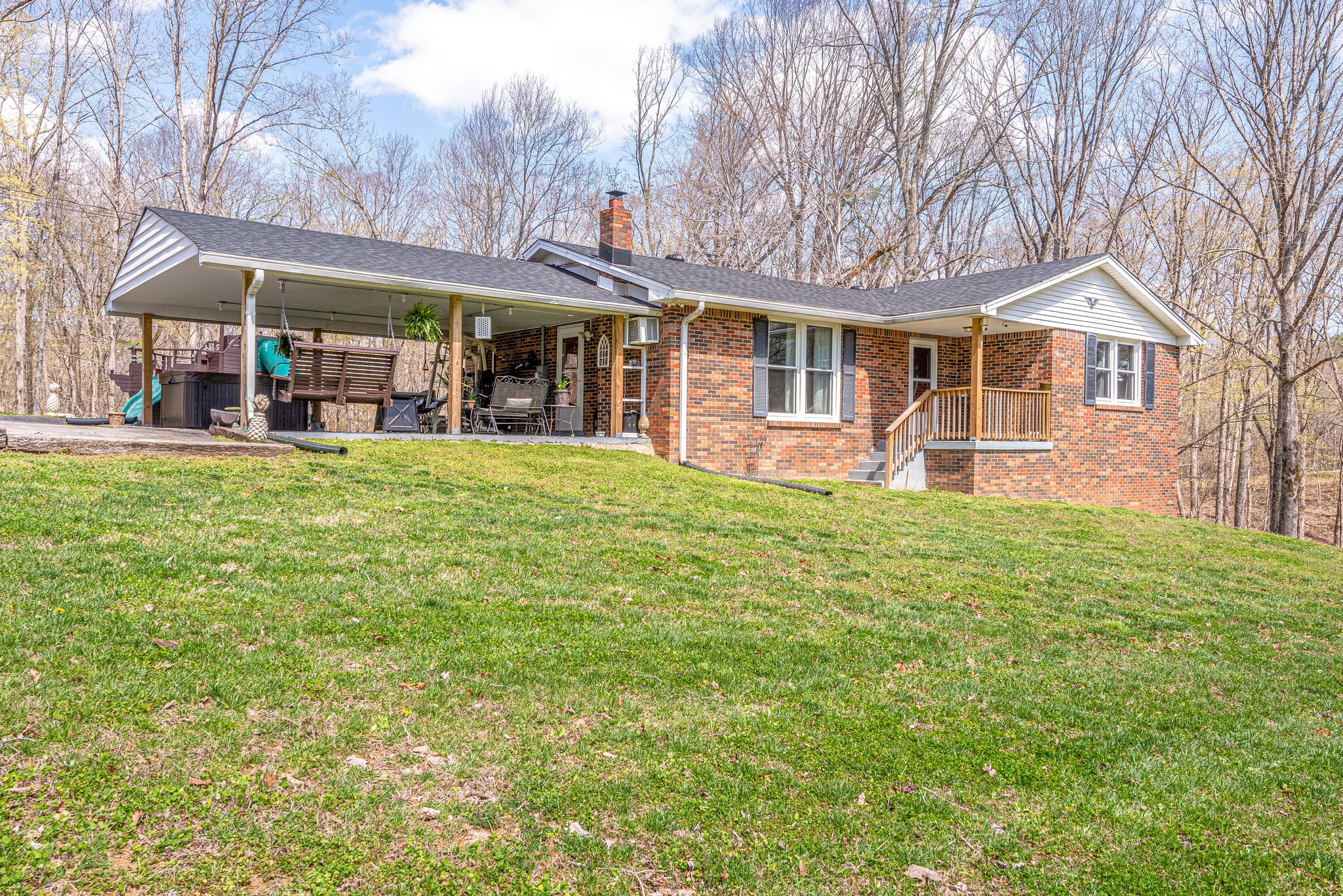 1065 Oak Grove Road Dickson, TN 37055 - Photo 1 of 30 a front view of a house with a yard table and chairs