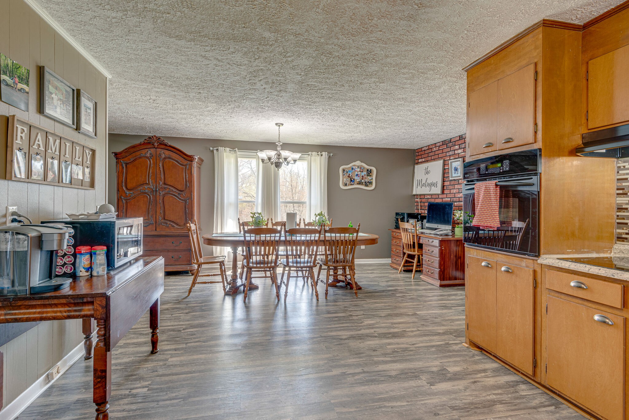 1065 Oak Grove Road Dickson, TN 37055 - Photo 4 of 30 a open kitchen with stainless steel appliances granite countertop a stove top oven a dining table and chairs with wooden floor
