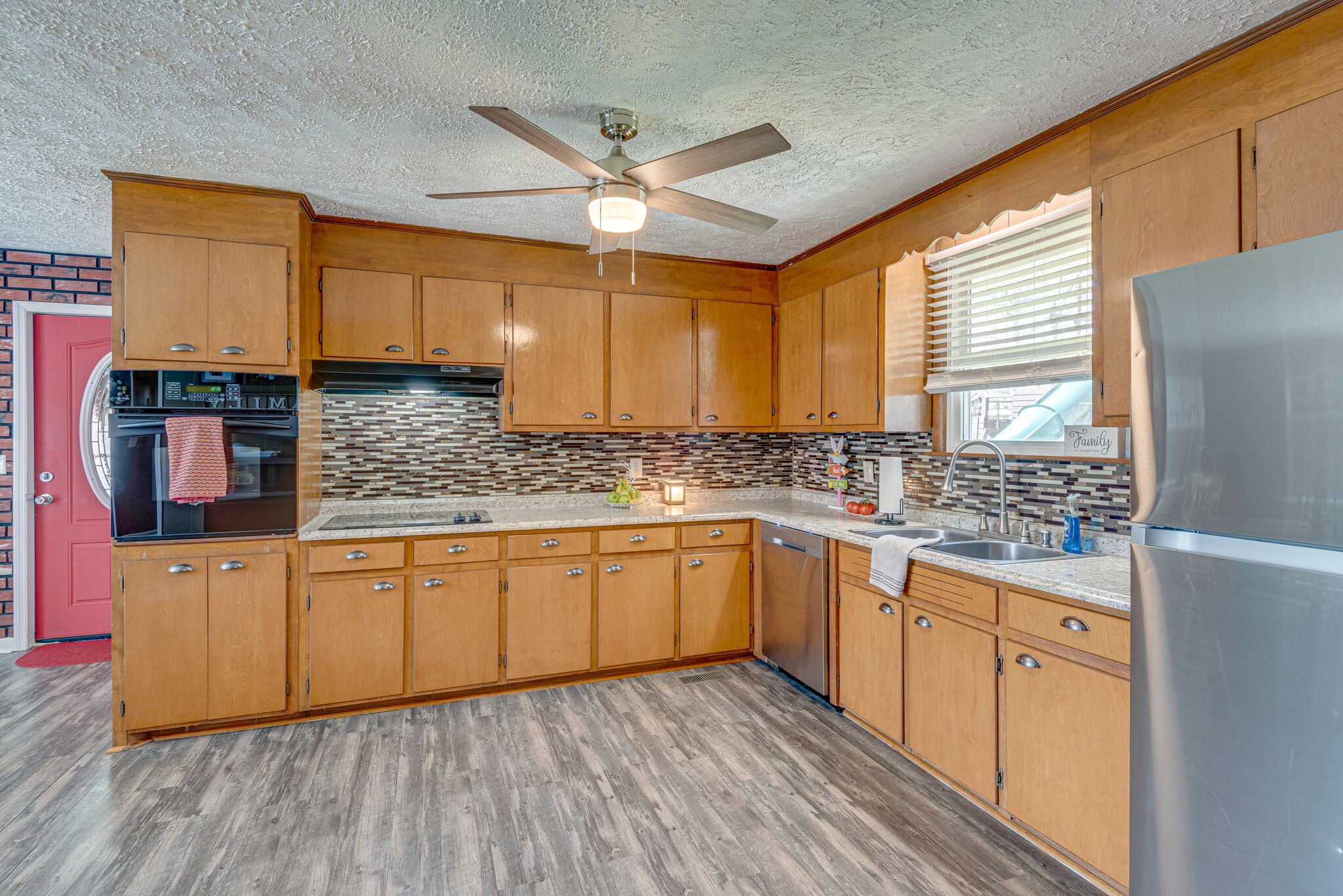1065 Oak Grove Road Dickson, TN 37055 - Photo 6 of 30 a kitchen with stainless steel appliances granite countertop wooden cabinets a sink a stove a refrigerator and island with wooden floor