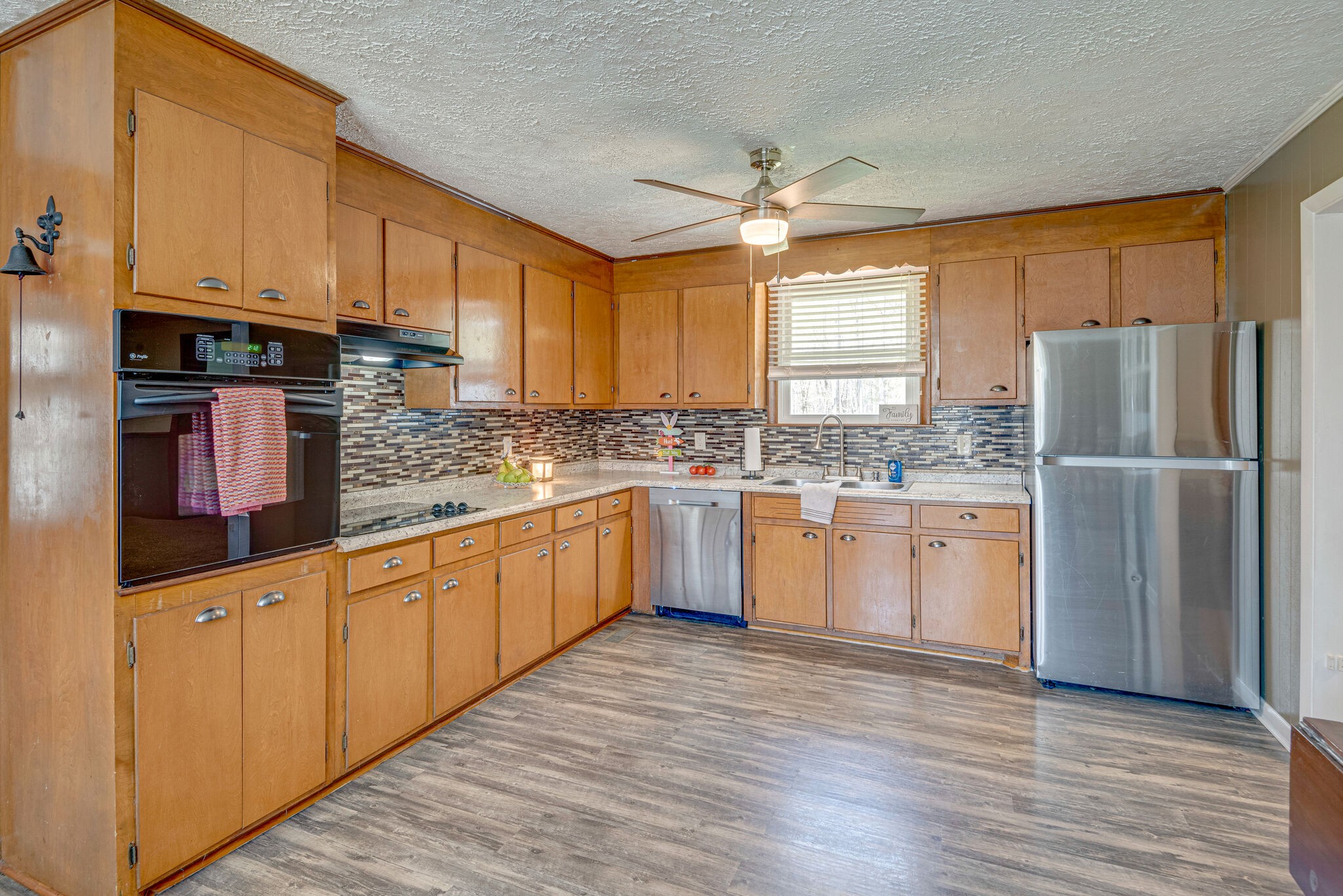 1065 Oak Grove Road Dickson, TN 37055 - Photo 7 of 30 a kitchen with stainless steel appliances granite countertop a refrigerator a sink dishwasher a microwave oven with cabinets and wooden floor