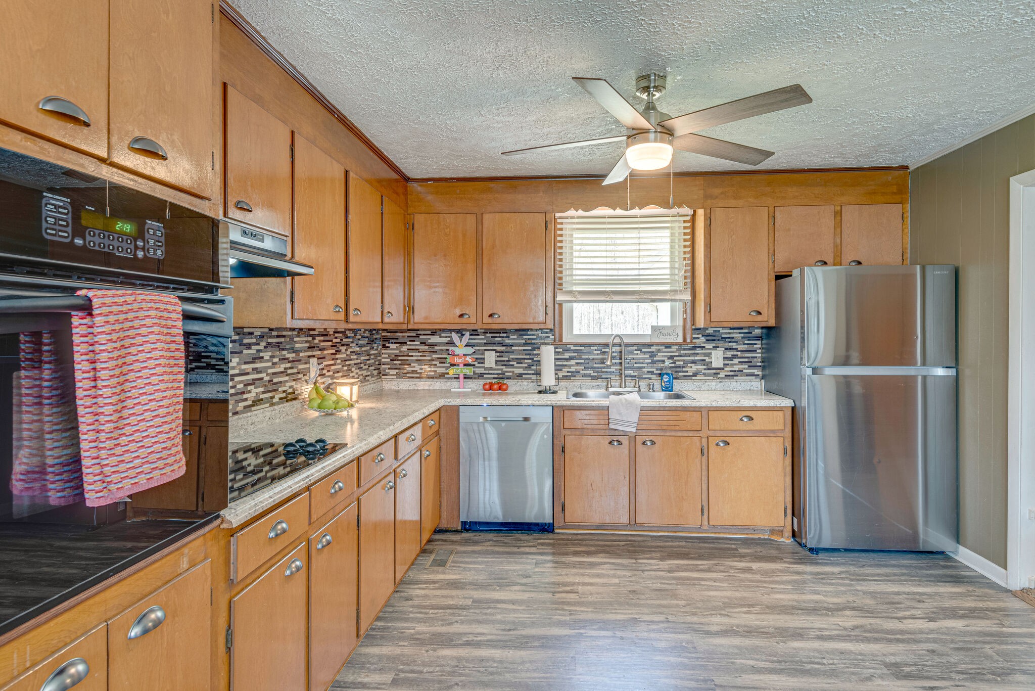 1065 Oak Grove Road Dickson, TN 37055 - Photo 8 of 30 a kitchen with stainless steel appliances granite countertop a refrigerator a sink dishwasher a stove top oven a refrigerator with island and cabinets