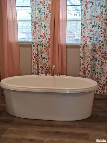 a bathroom with a bathtub and window