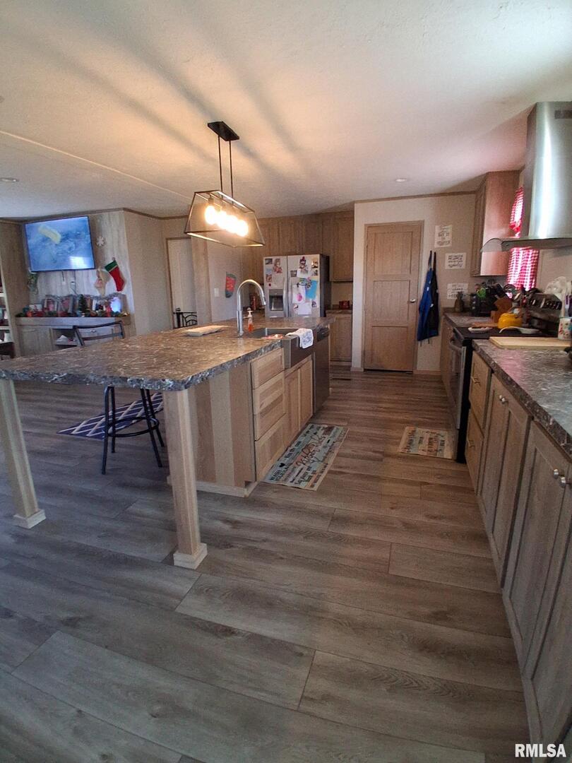 1300 Jackson Avenue Sandoval, IL 62882 - Photo 6 of 16 a kitchen with kitchen island granite countertop wooden floors and a view of living room