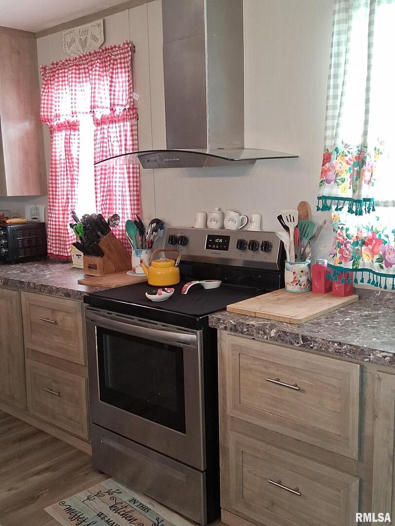 1300 Jackson Avenue Sandoval, IL 62882 - Photo 8 of 16 a kitchen with granite countertop wooden cabinets and a stove top oven