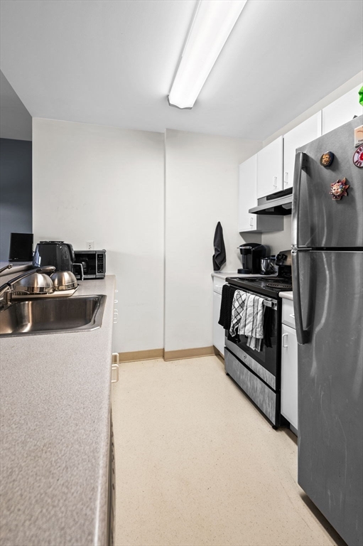 636 Beacon Street, Unit 605 Boston, MA 02215 - Photo 12 of 23 a kitchen with a refrigerator and a stove top oven