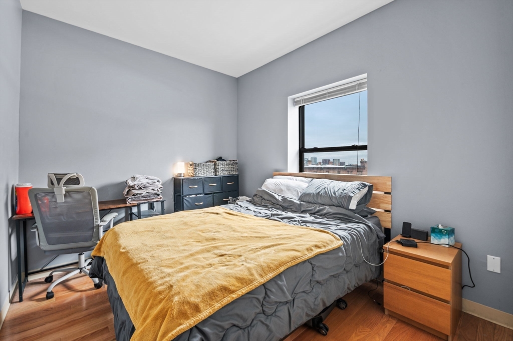636 Beacon Street, Unit 605 Boston, MA 02215 - Photo 14 of 23 a bed sitting in a bedroom next to a window with chair