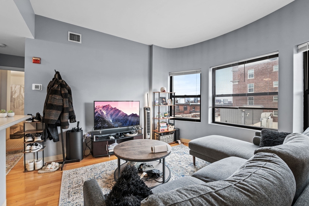 636 Beacon Street, Unit 605 Boston, MA 02215 - Photo 3 of 23 a living room with furniture a window and a flat screen tv