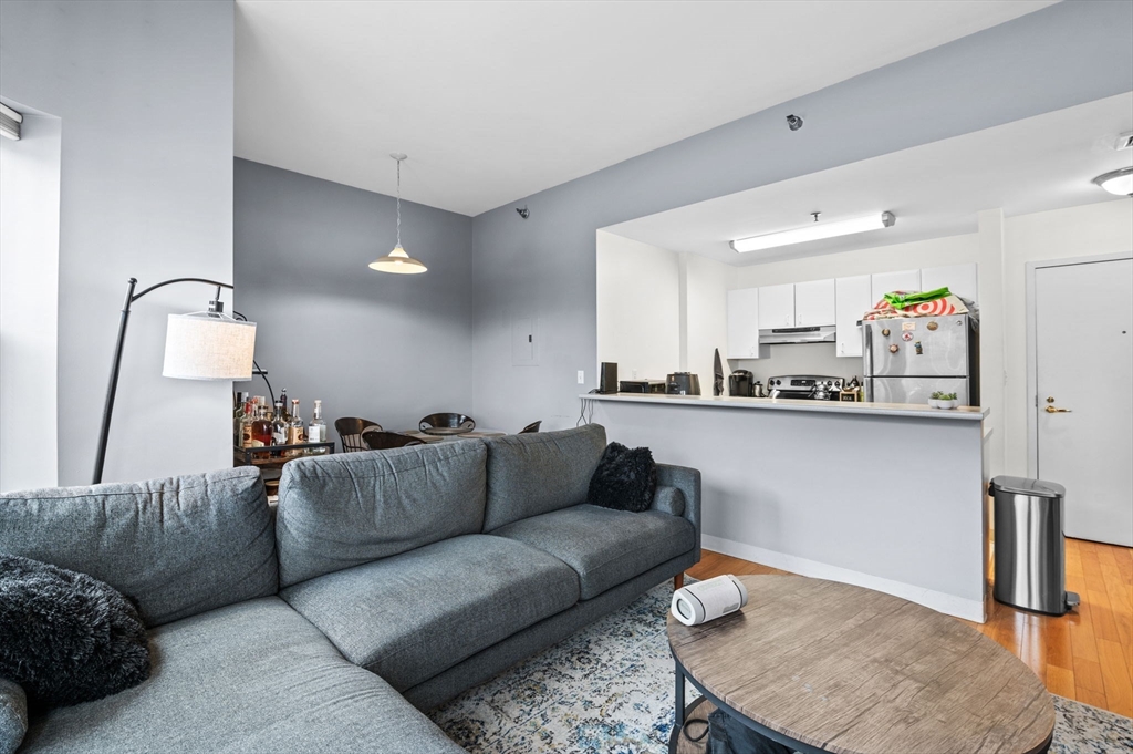 636 Beacon Street, Unit 605 Boston, MA 02215 - Photo 5 of 23 a living room with furniture and kitchen view