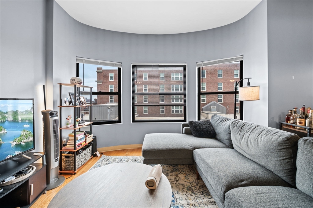 636 Beacon Street, Unit 605 Boston, MA 02215 - Photo 6 of 23 a living room with furniture and a flat screen tv