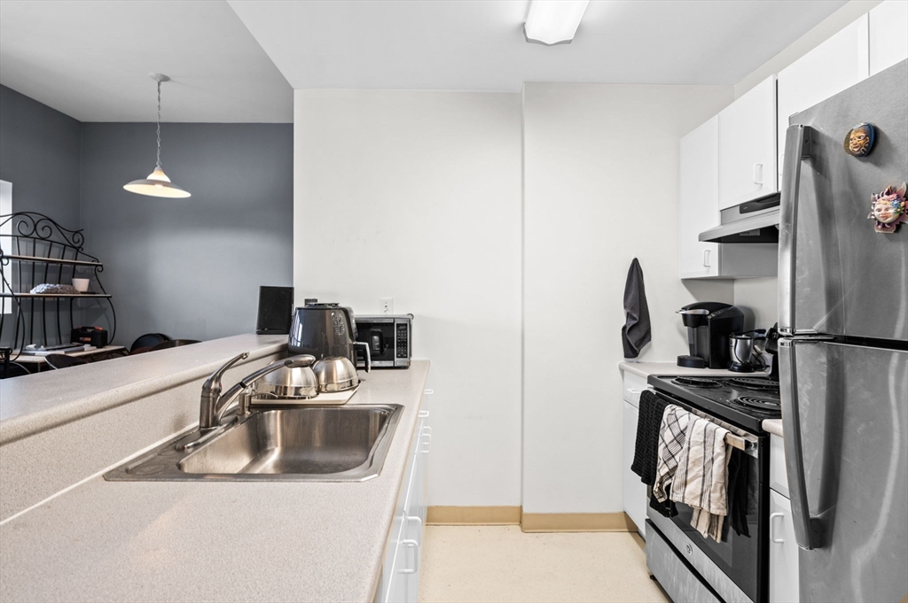 636 Beacon Street, Unit 605 Boston, MA 02215 - Photo 10 of 23 a kitchen with a sink and a refrigerator