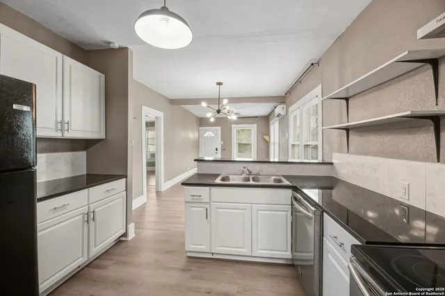 a kitchen with a sink stove and cabinets