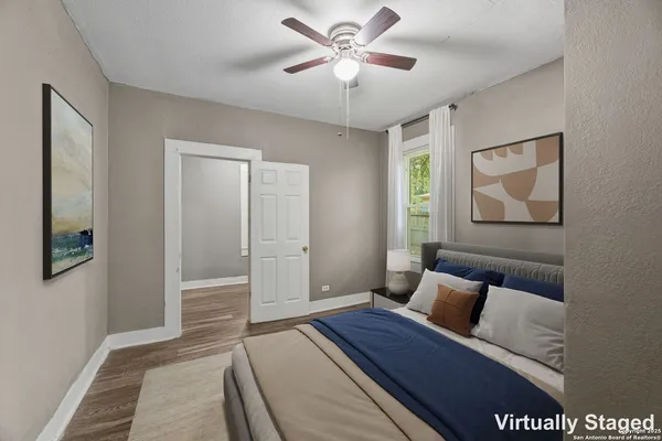 a bedroom with a bed and a painting on the wall