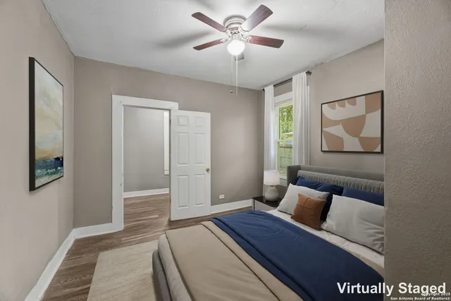 a bedroom with a bed and a painting on the wall