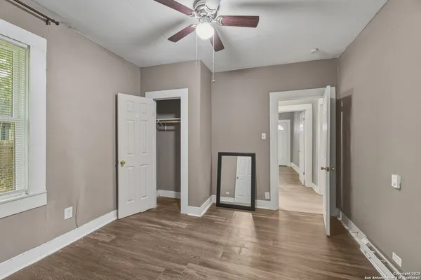 wooden floor in an empty room with a window
