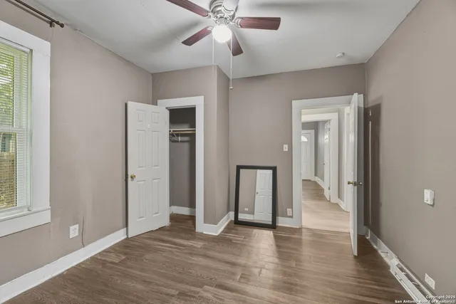 wooden floor in an empty room with a window