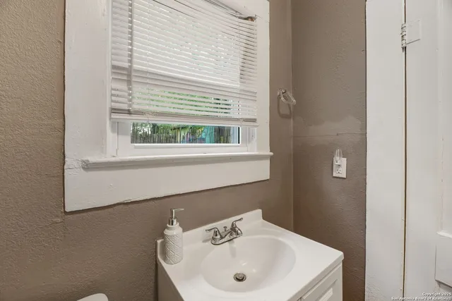 a bathroom with a sink and a window