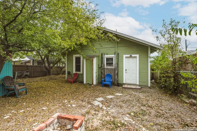 a view of a house with backyard porch and sitting area