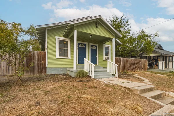 a front view of a house with a yard outdoor seating and garage