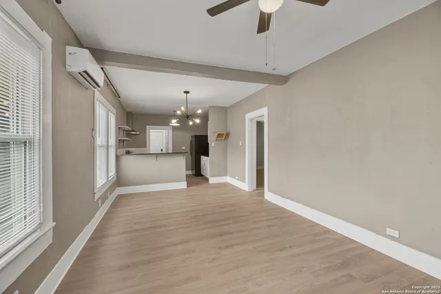 a view of a kitchen with a refrigerator a ceiling fan and a kitchen view