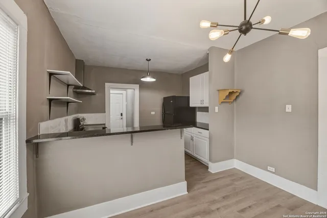 a kitchen with a sink a refrigerator and a stove