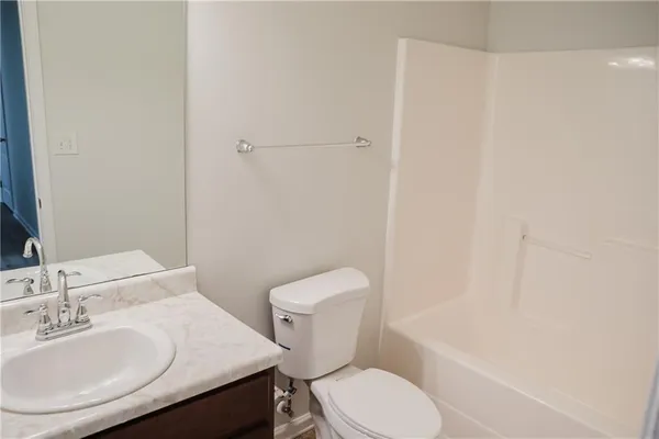 a white toilet sitting next to a bathroom sink