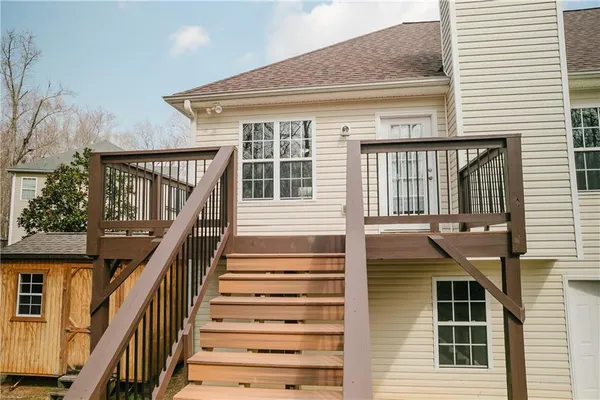 a front view of a house with wooden stairs and windows