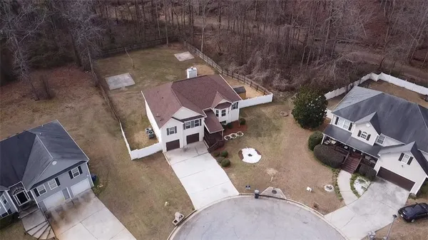 an aerial view of a house with a yard