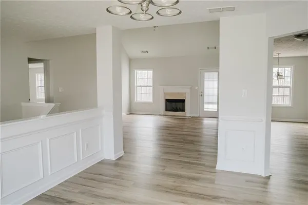 a view of livingroom and kitchen with wooden floor