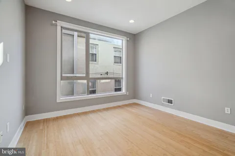 a kitchen with stainless steel appliances granite countertop a stove a sink dishwasher a refrigerator and a microwave oven with wooden floor