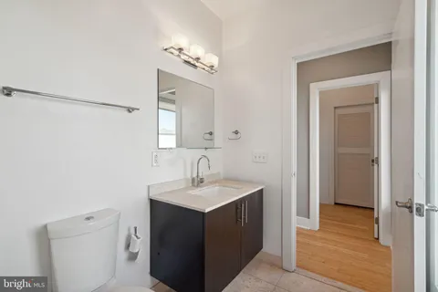 a bathroom with a toilet a sink and mirror