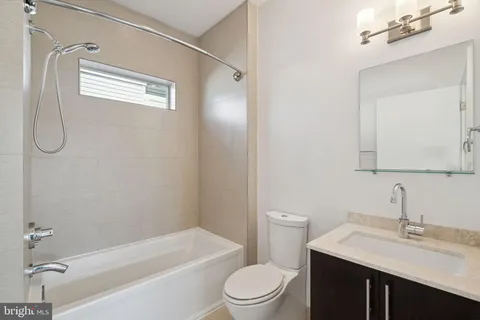a view of a room with an empty space and windows