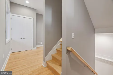 a view of an empty room with closet and a window