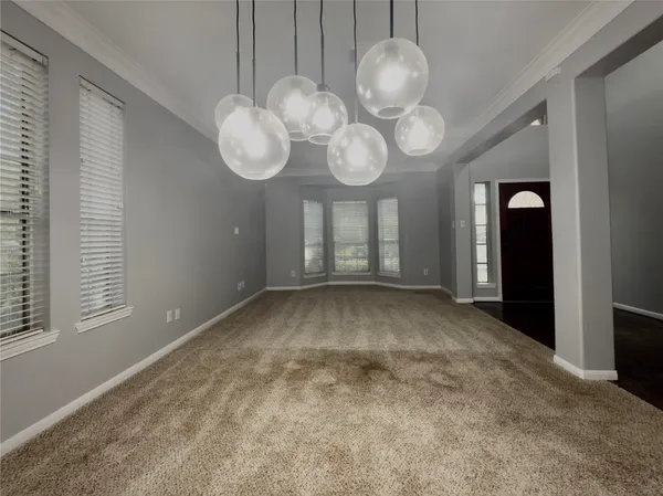 a view of a room with wooden floor and chandelier