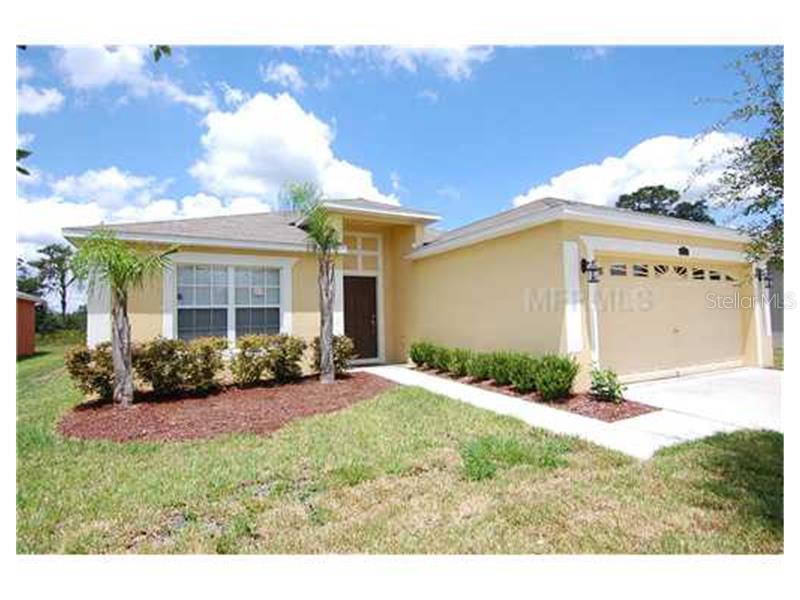 4001 Constantine Loop Wesley Chapel, FL 33543 - Photo 1 of 1 a front view of a house with garden