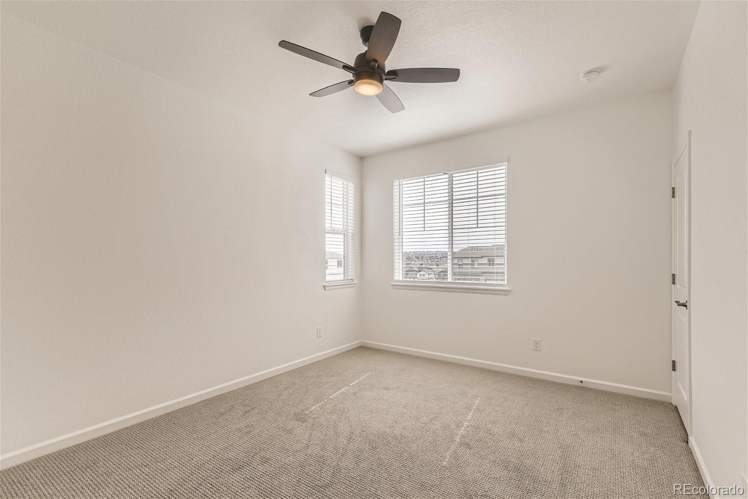 12659 Boggs Street Parker, CO 80134 - Photo 14 of 28 an empty room with a window and a ceiling fan