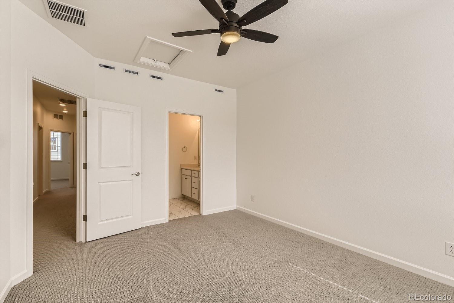 12659 Boggs Street Parker, CO 80134 - Photo 15 of 28 an empty room with closet and a chandelier fan