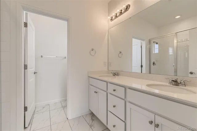 a bathroom with a double vanity sink and mirror