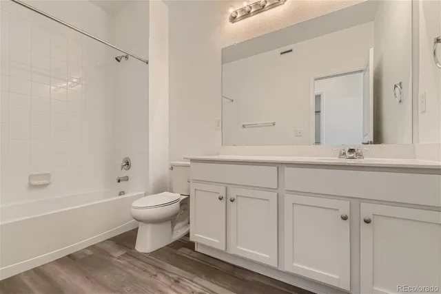 a bathroom with a sink toilet a mirror and shower