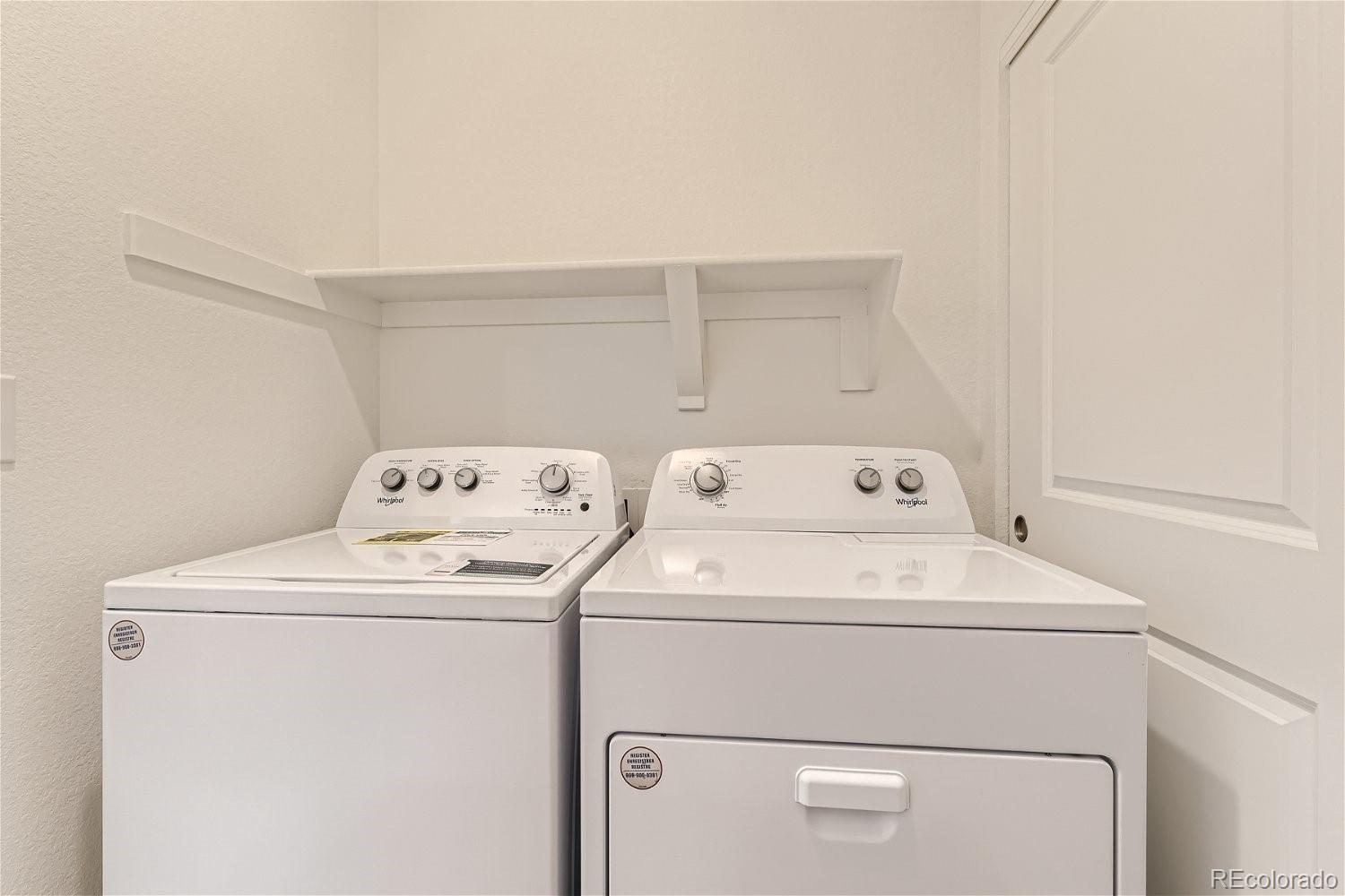 12659 Boggs Street Parker, CO 80134 - Photo 23 of 28 a utility room with dryer and washer