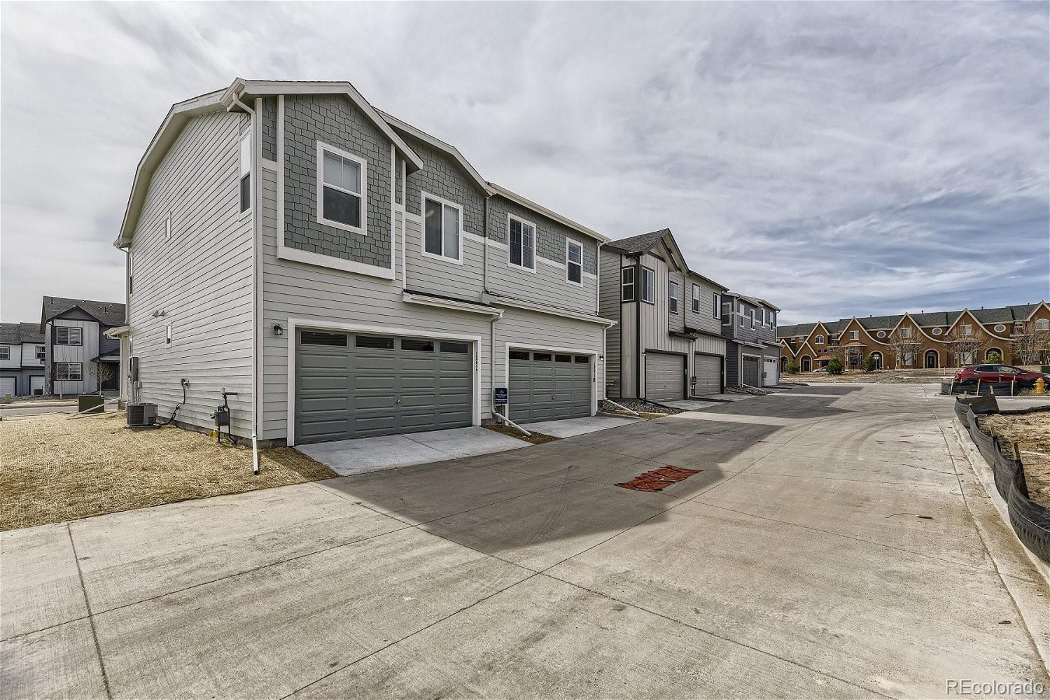 12659 Boggs Street Parker, CO 80134 - Photo 27 of 28 a front view of a house with a yard
