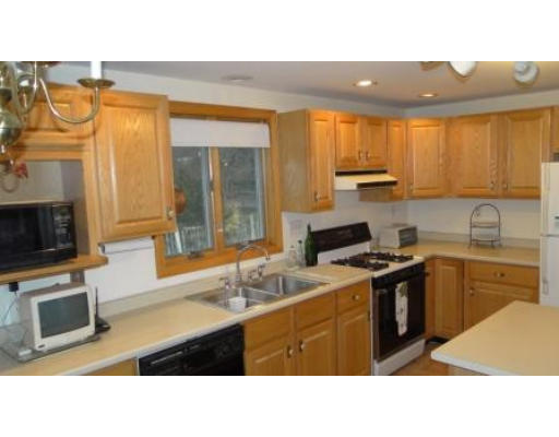 2 Melvin Road Natick, MA 01760 - Photo 3 of 8 a kitchen with stainless steel appliances granite countertop a sink stove and refrigerator