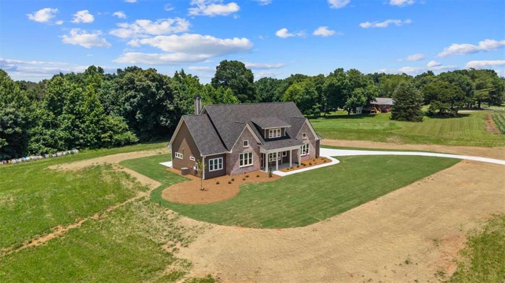 591 Welcome Road Roopville, GA 30170 - Photo 54 of 60 an aerial view of a house with swimming pool and big yard