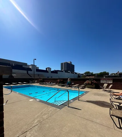a large white kitchen with stainless steel appliances kitchen island a stove and white cabinets