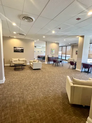 a room with lots of furniture and wooden floors