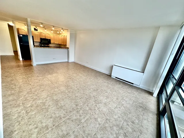 a kitchen with stainless steel appliances granite countertop a sink a stove and a refrigerator