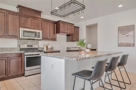 a kitchen with stainless steel appliances granite countertop a stove a sink dishwasher and a refrigerator