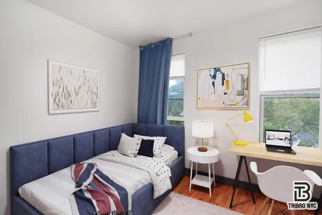 a bedroom with a bed and painting on the wall