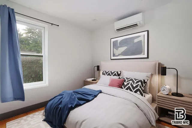 a bedroom with a bed and a window