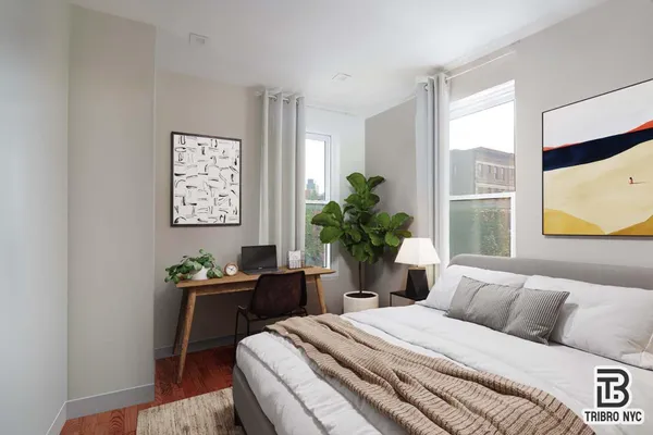 a bedroom with a bed table chair and window