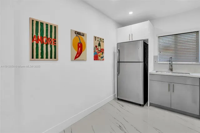 a white refrigerator freezer sitting in a kitchen